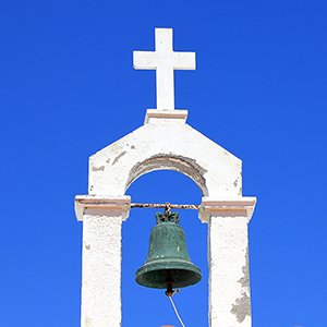 Cross and bell against the sky
