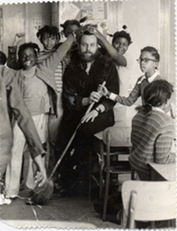 A man surrounded by playful children