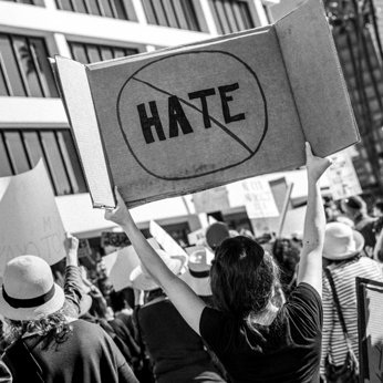 Person with sign against hate at a protest