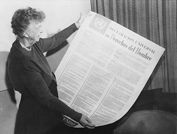 Eleanor Roosevelt holds a Spanish copy of the Universal Declaration of Human Rights