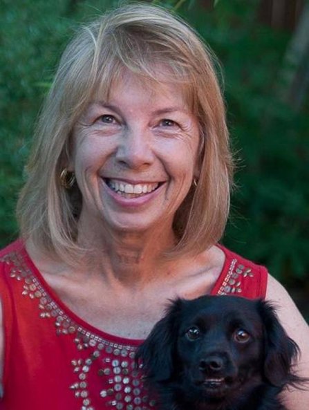 Jeannie, Wayne’s wife, holding a black dog