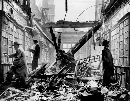 People browse a library in London with its roof caved in after an air raid