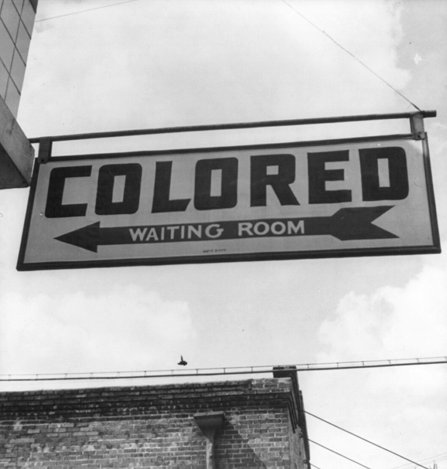 A sign reading: colored waiting room