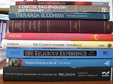 A stack of books on various religions