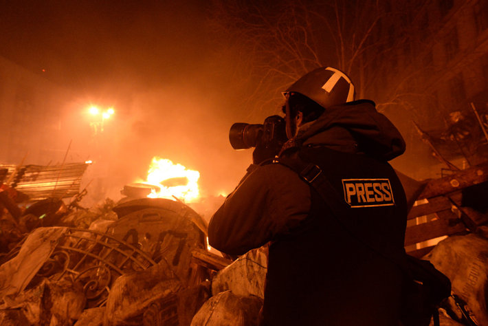 Journalist photographing a fire.