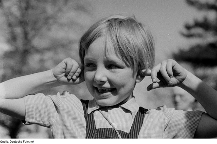 Kid with fingers in ears, not listening