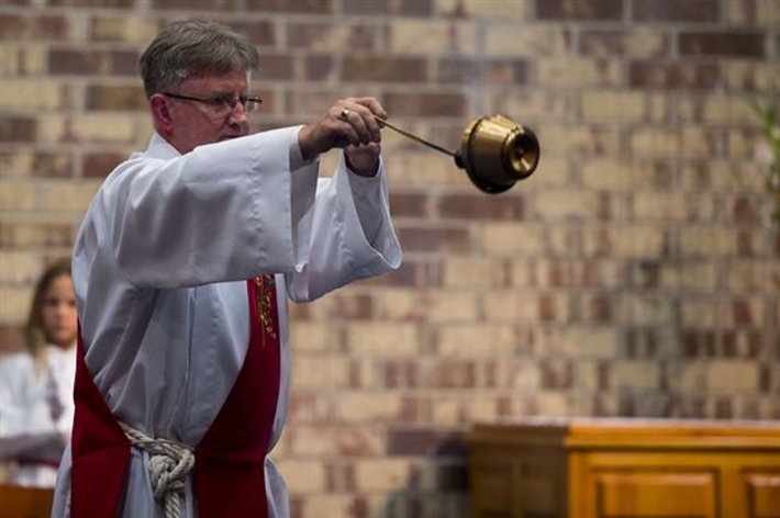 Catholic bishop swings incense