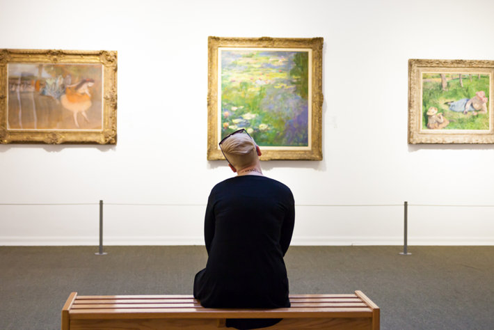 Woman looking at paintings