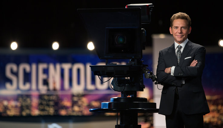 Scientology ecclesiastical leader David Miscavige with a camera