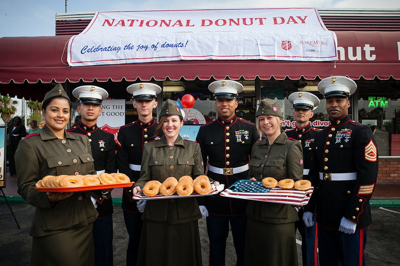 Salvation Army members offer platters of donuts for National Donut Day