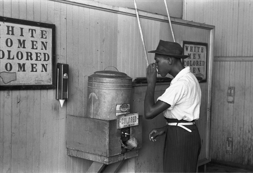 Man drinking from a segregated water fountain