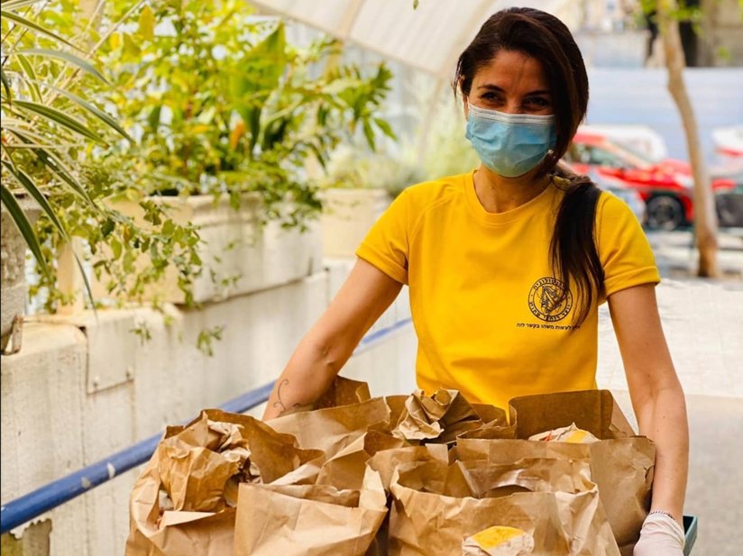 Volunteer with food bags