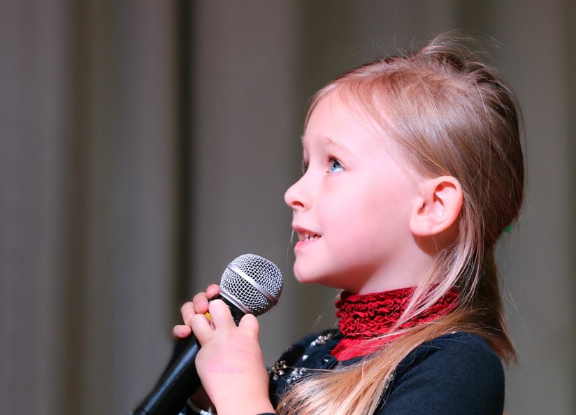 A little girl with a microphone