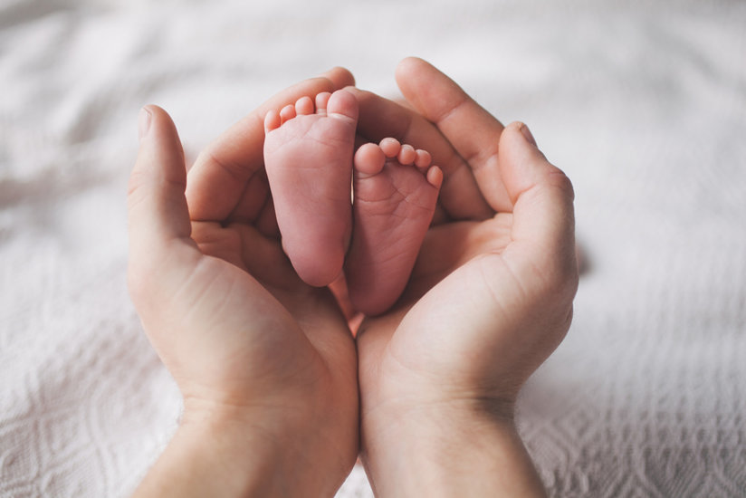 Woman holding baby’s feet