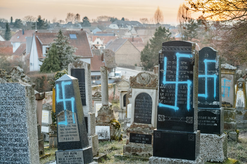 Gravestones with swastikas painted on them