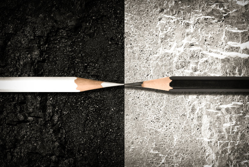 Black pencil facing a white pencil