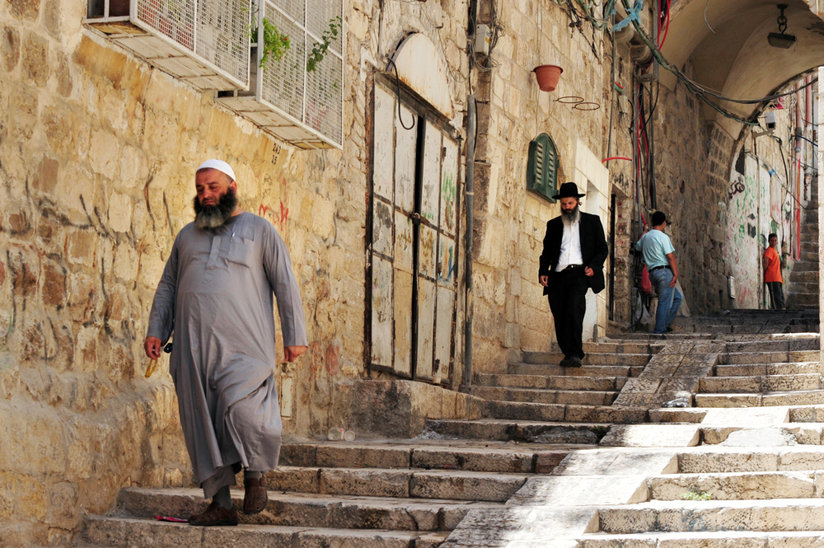 Jewish man walking behind Muslim man