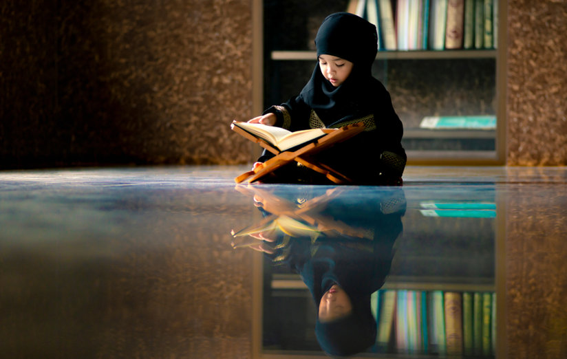 Little Muslim girl reading