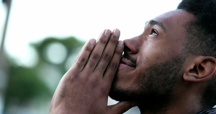 Man praying, looking to the sky