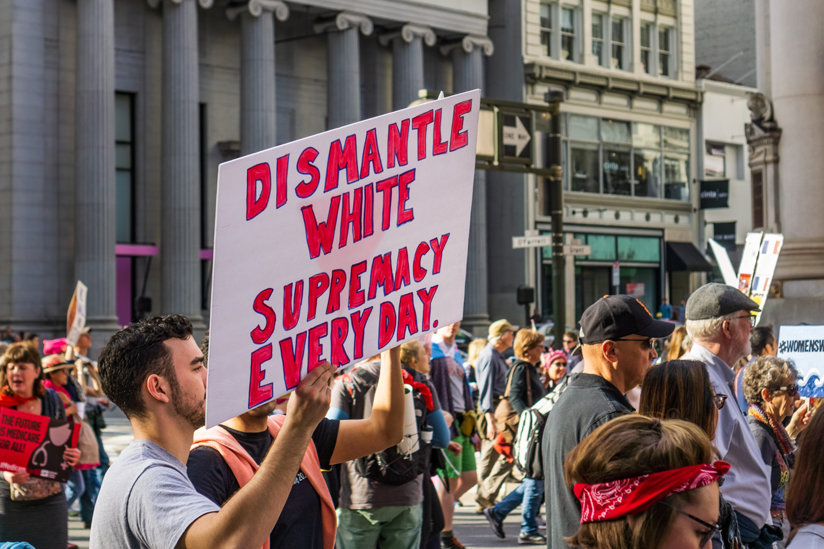 Man holding sign against white supremacy