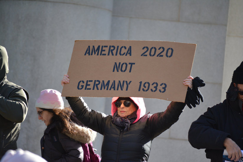 Woman holding sign