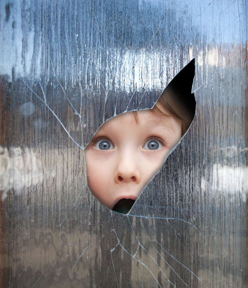 Child peaking through break in glass