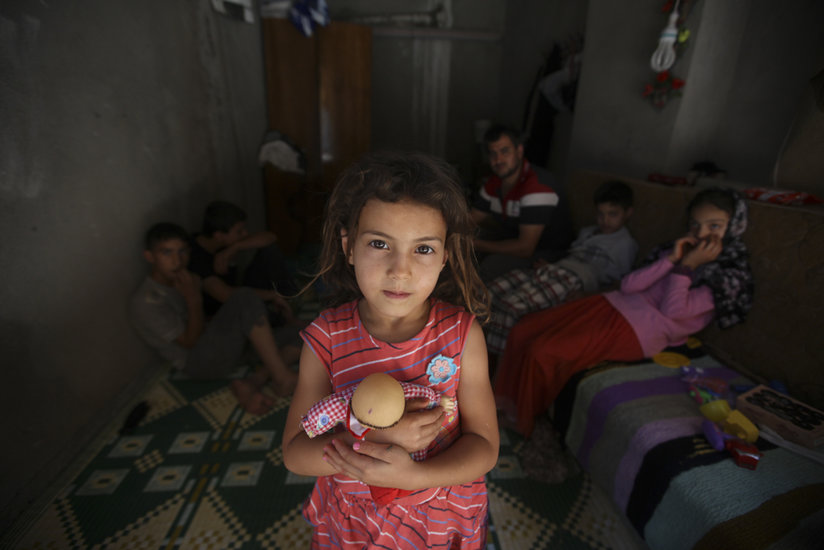 Little girl holding doll