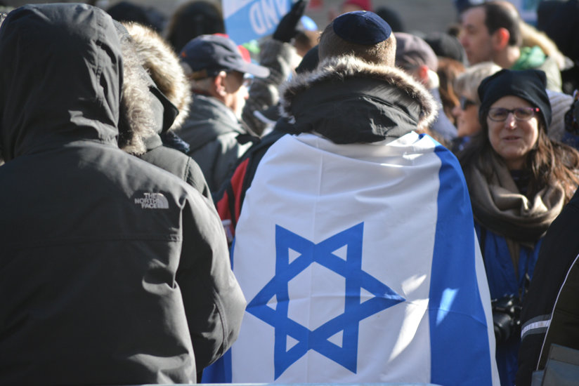 Man with Israeli flag wrapped around him