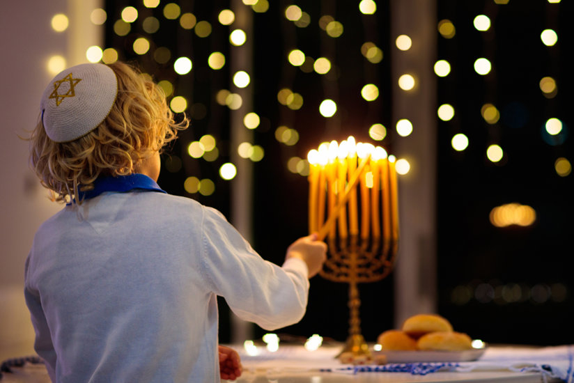 Jewish boy lighting candles